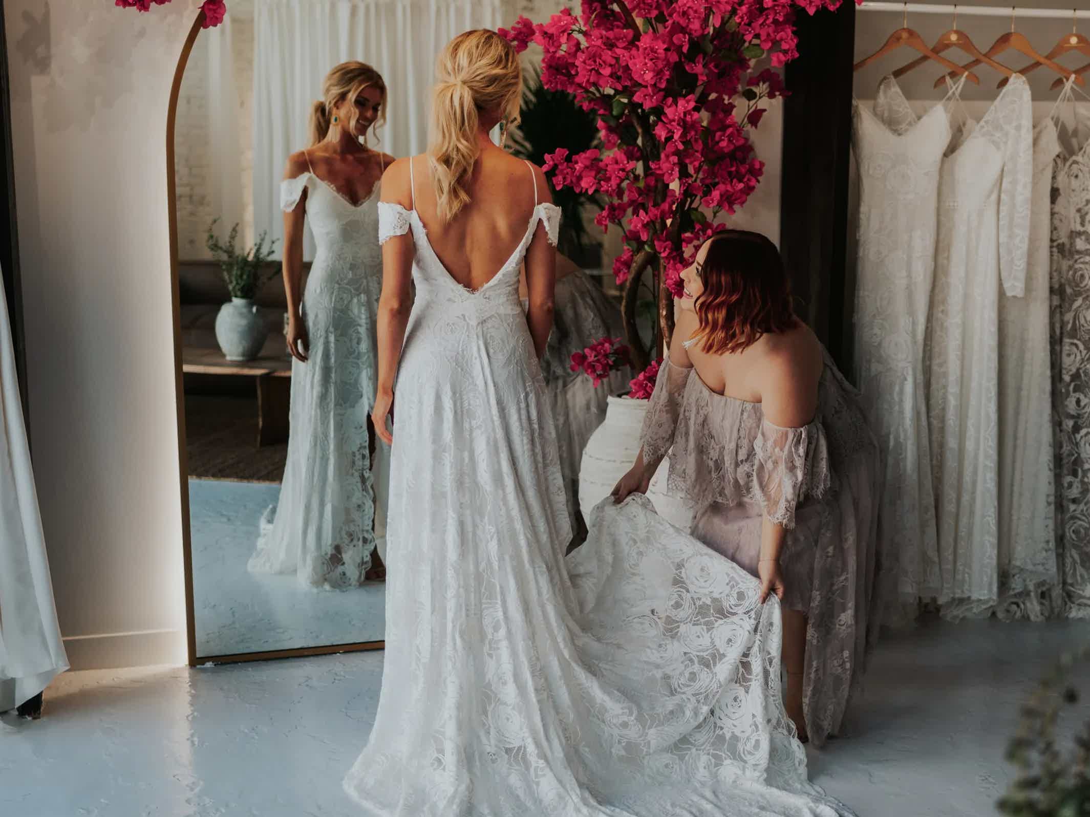 Die Stylistin von Grace Loves Lace hilft der Braut im Showroom in Phoenix