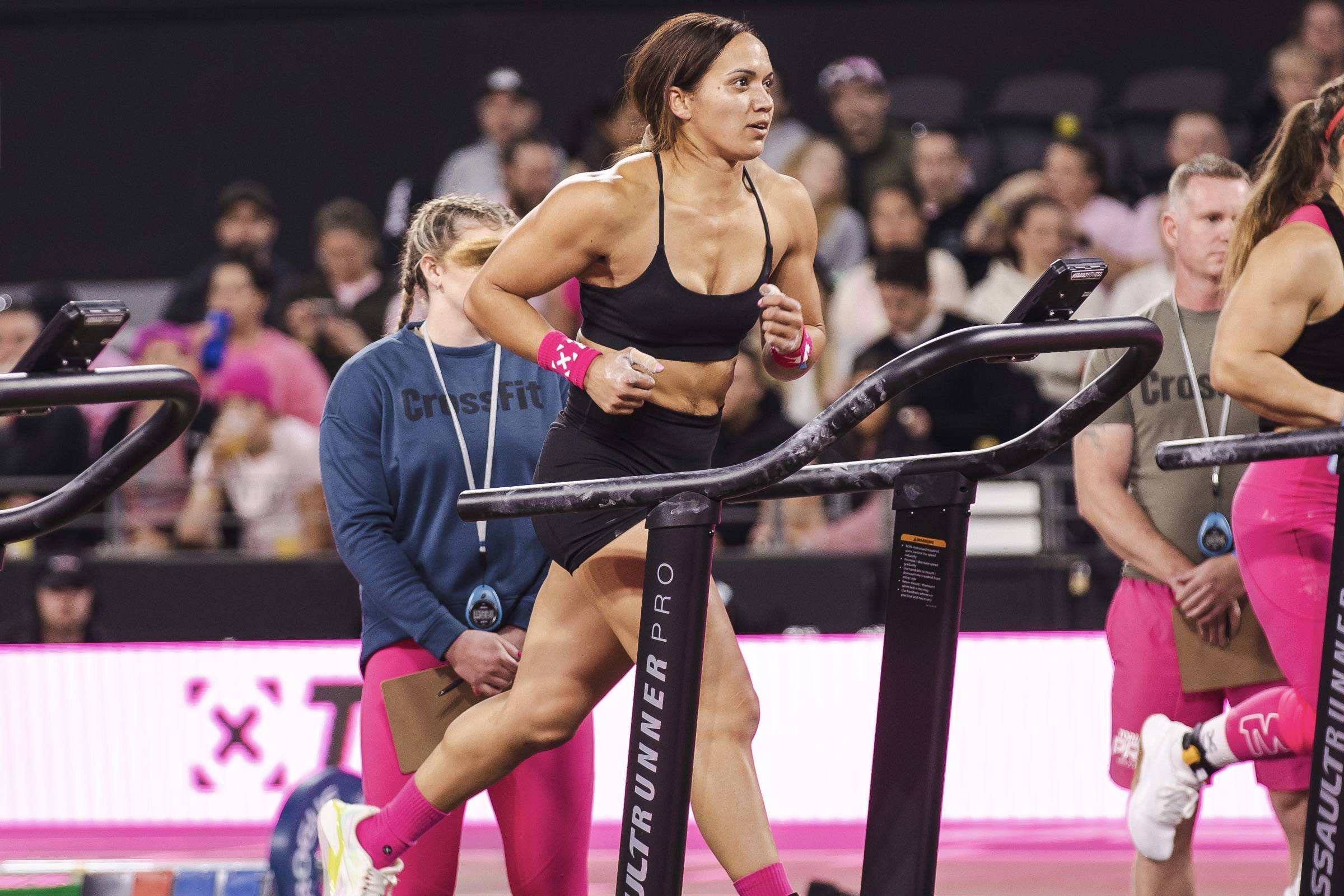 girl running on a tredmill during a crossfit workout