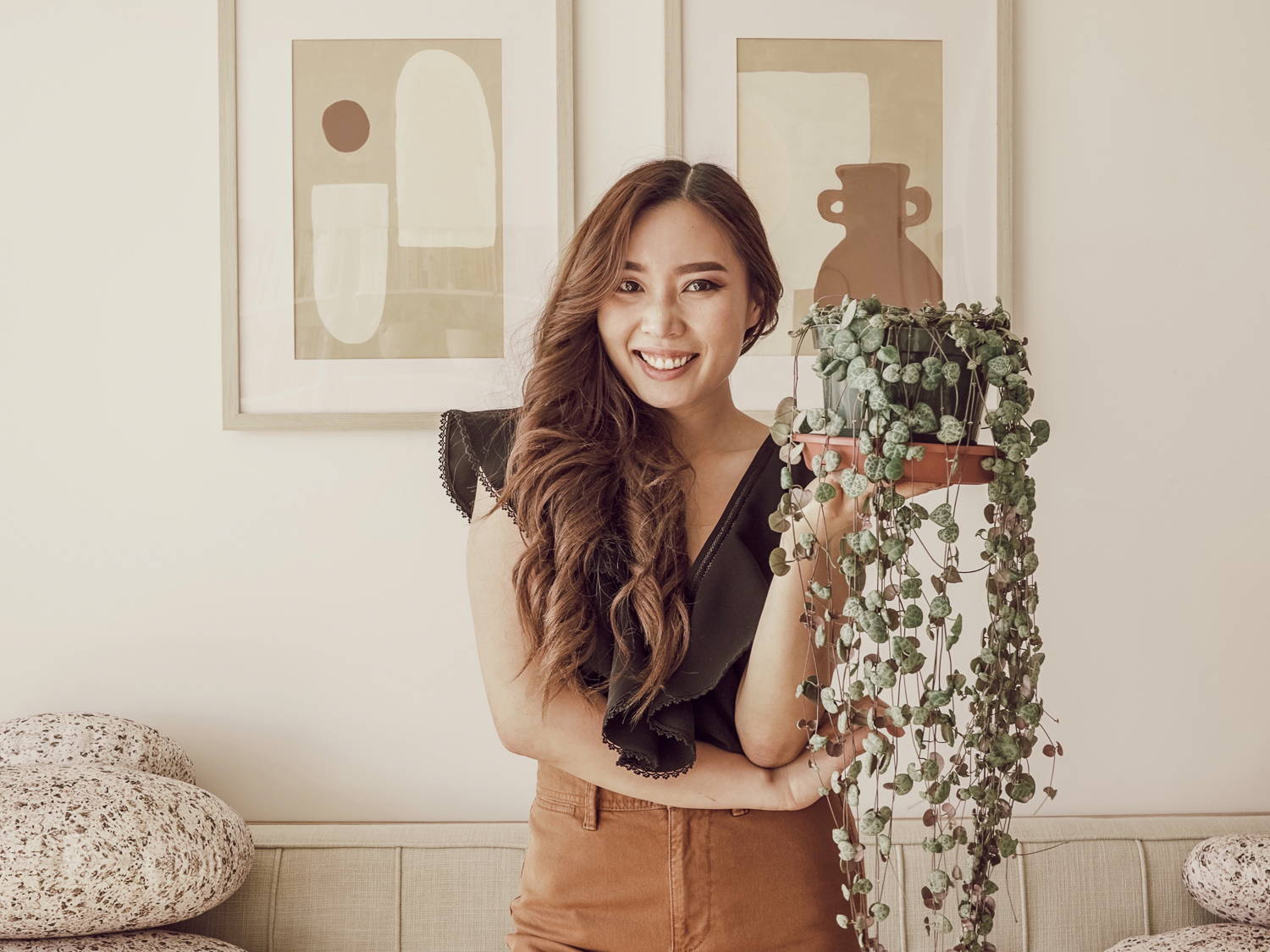 Picture of Anh Lin holding a pot with plant