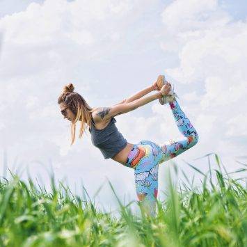 Woman Doing Yoga In A Field 