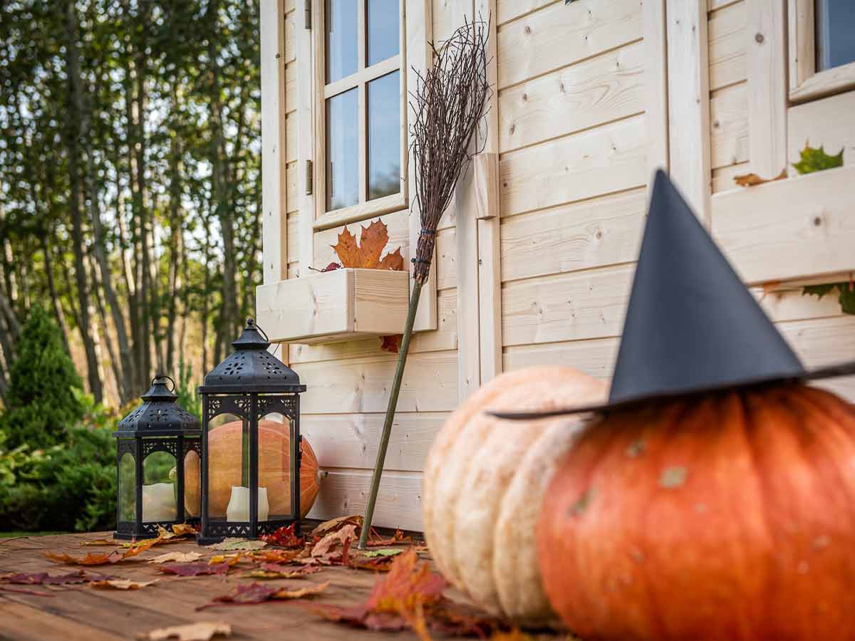 Kids Wooden Playhouse with Halloween pumpkins and candle lanterns by WholeWoodPlayhouses
