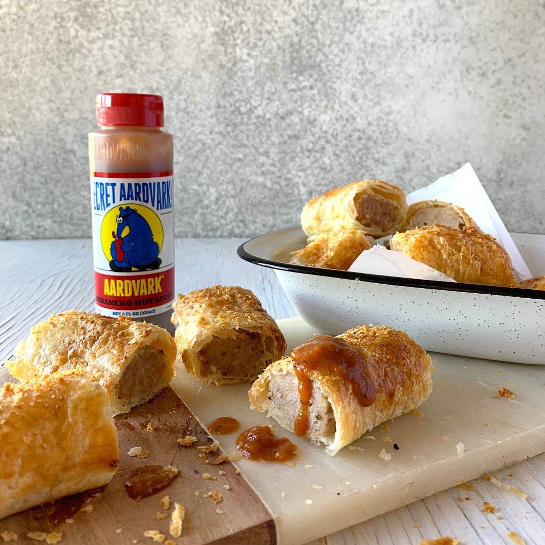 Homemade sausage rolls with hot sauce