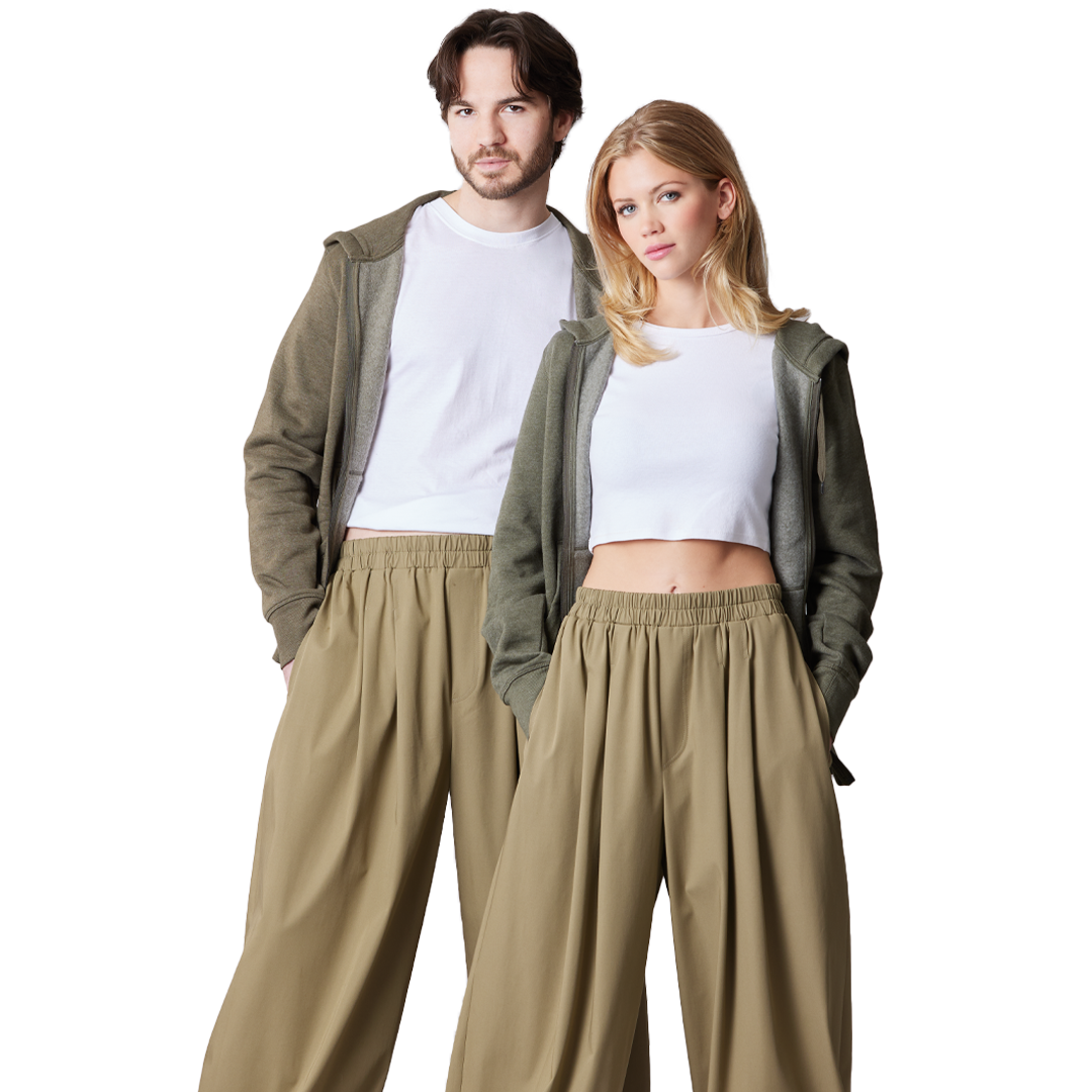 Man and woman in casual outfits, standing together, smiling.