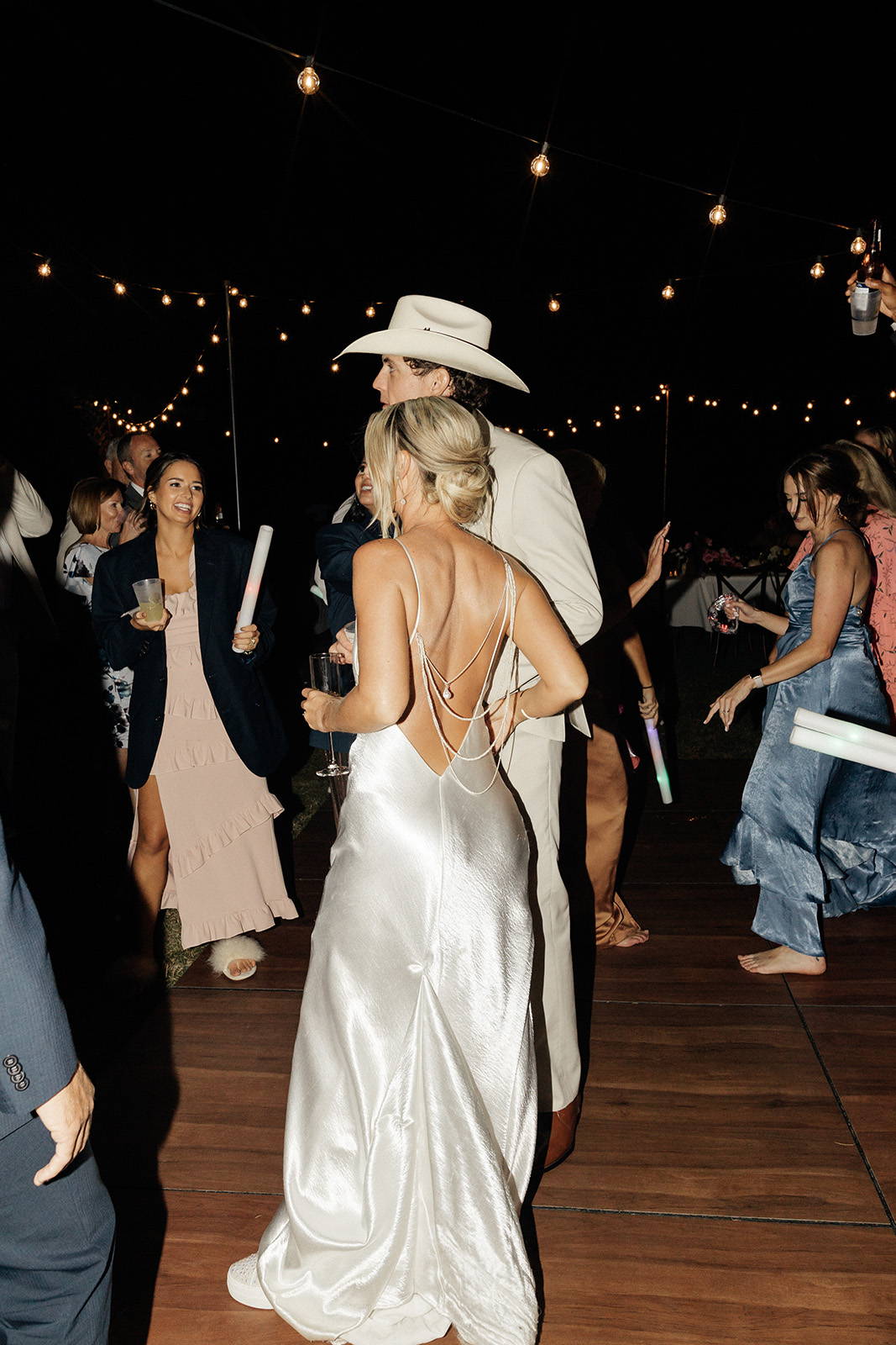 Bride and groom on the dance floor with back detailing of the Oceania gown