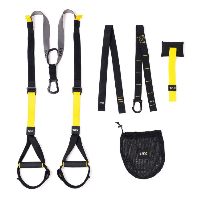 Person performing a TRX exercise in a home gym setting.