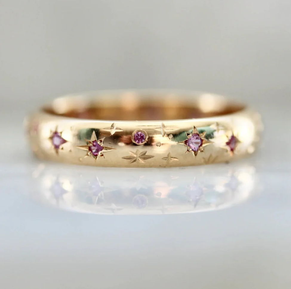 Hand-engraved star wedding band with star set pink sapphires
