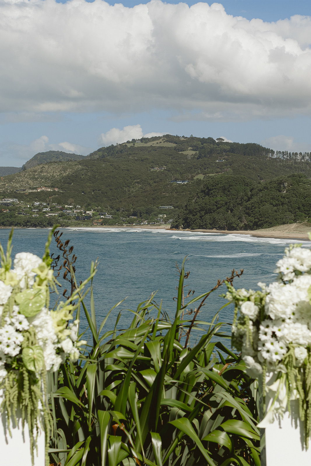Scenic view of a beach with floral arrangements in the foreground.