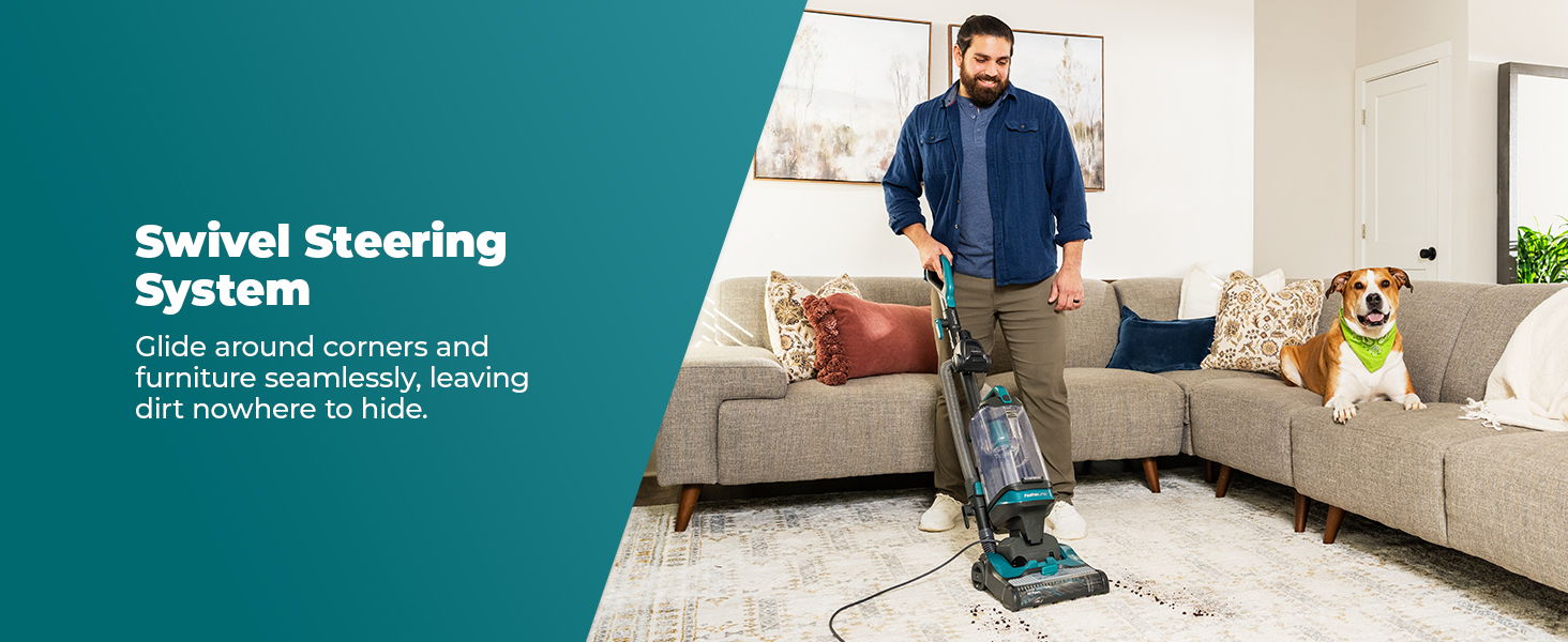 Man vacuuming with a dog beside him in a living room setting.