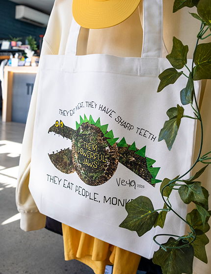 Natural canvas tote bag printed with a DTF print of childs dinosaur drawing