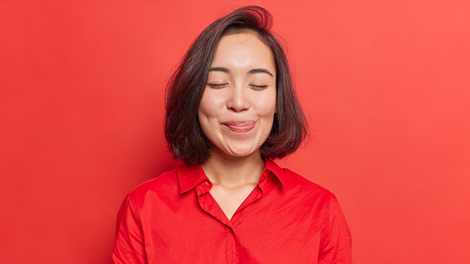 A picture of a woman licking her lips.