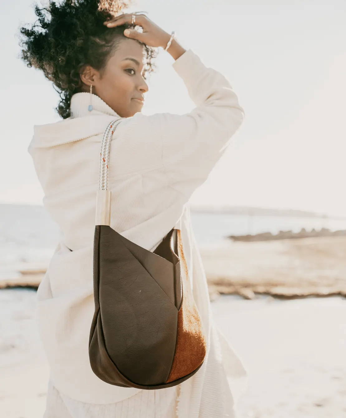 woman wearing brown leather bag on her shoulder