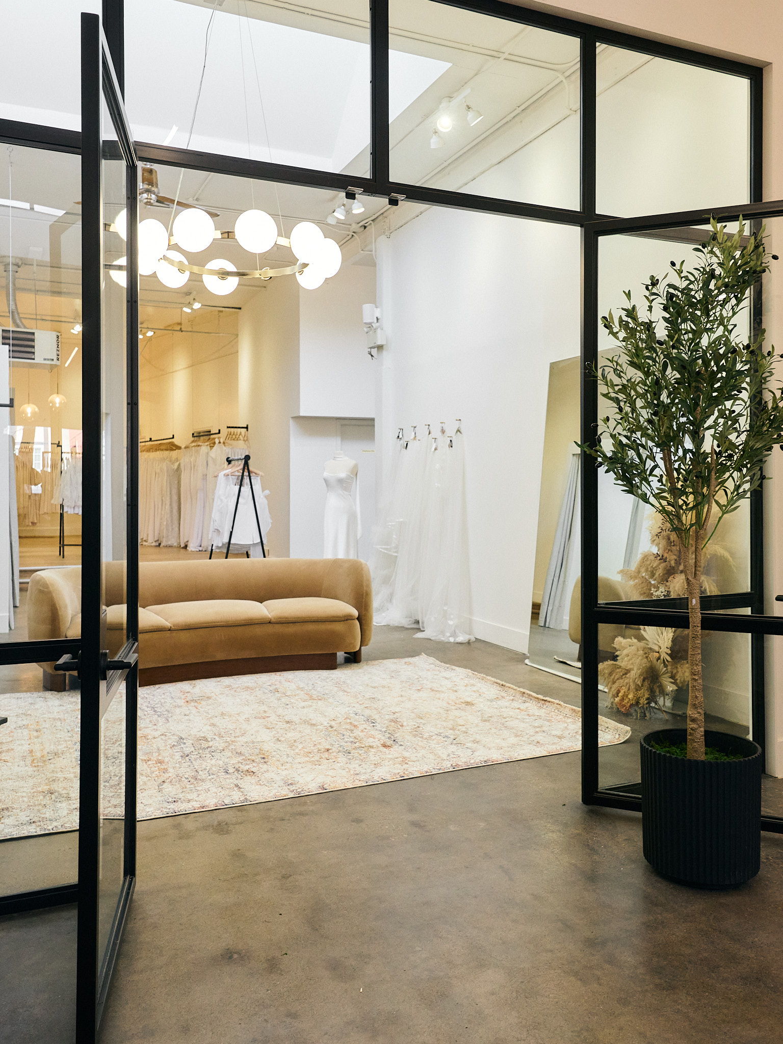 Stylish interior with a sofa, plants, and modern lighting.