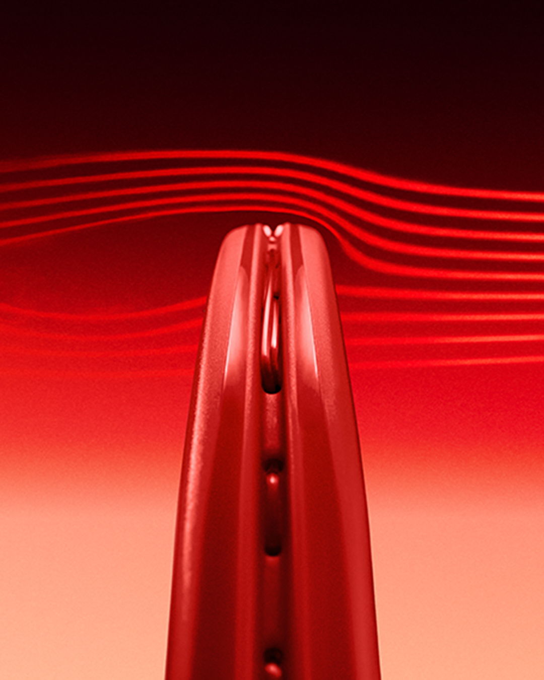 Close-up of a red object with curved lines in the background.