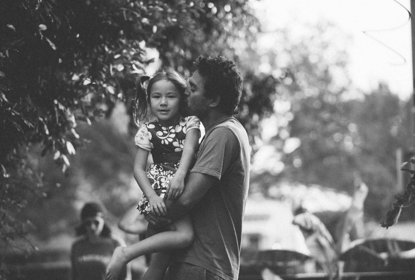 Chris kissing daughter's cheek