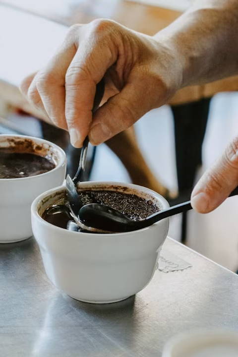 person mixing black coffee