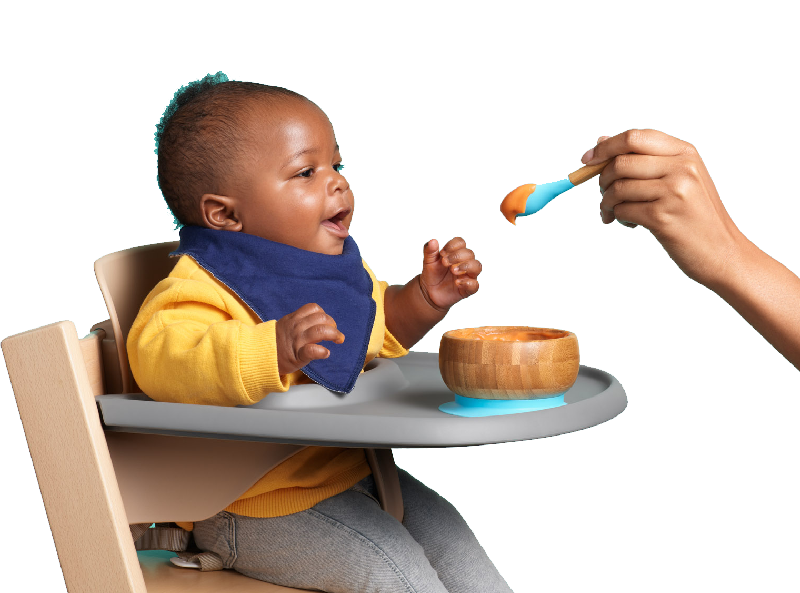 Child eating SpoonfulONE Mix-ins with sweet potato