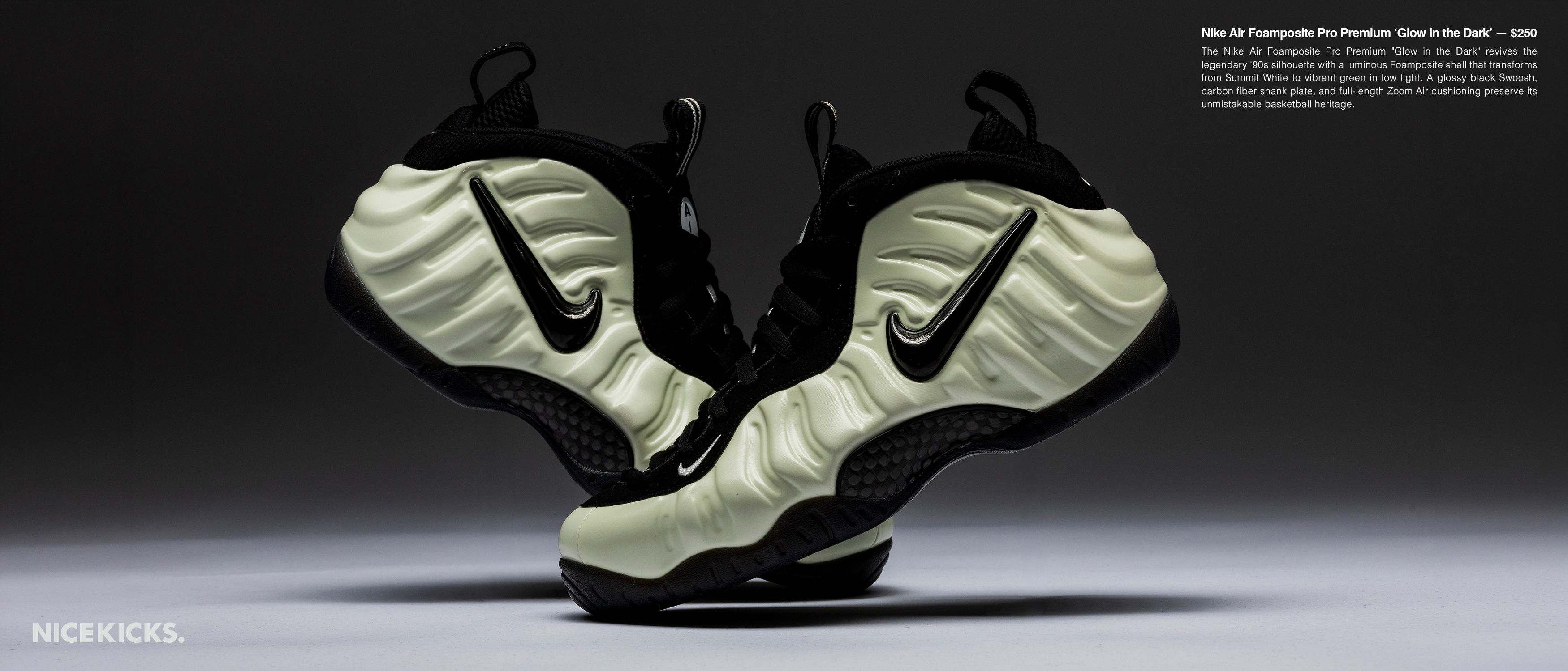 A pair of Nike Foamposite sneakers on a dark background.