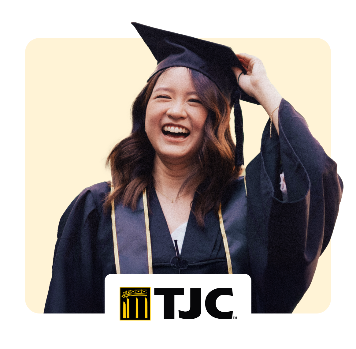 Happy graduate wearing cap and gown, celebrating with a smile.