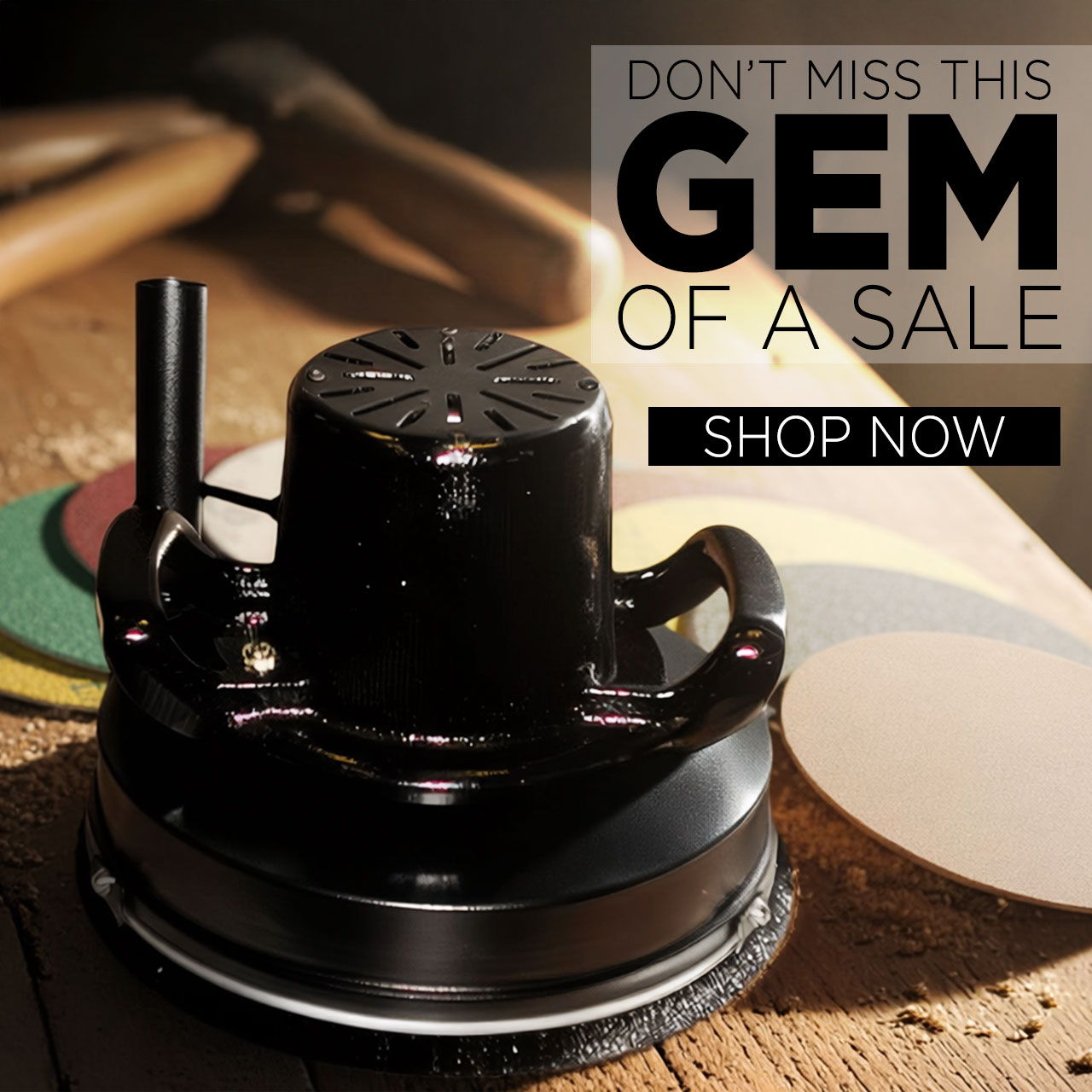 Black tool on a wooden surface with a sale advertisement.