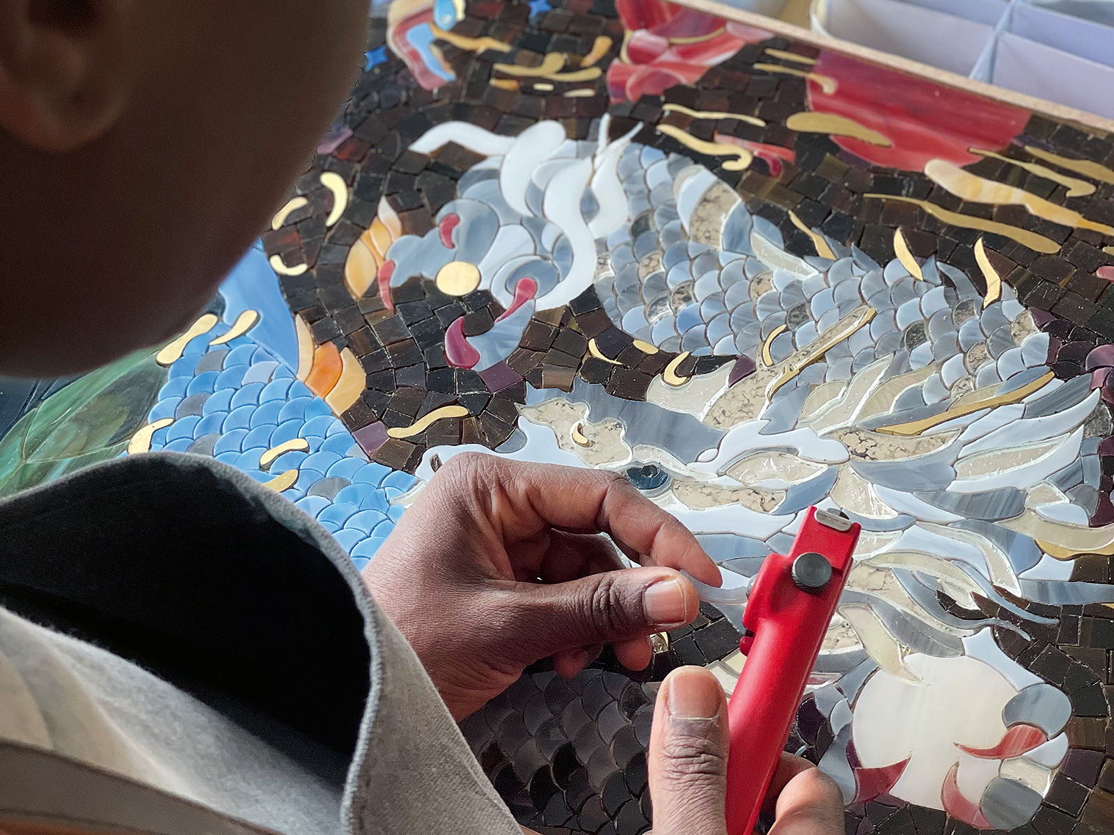 Sika Viagbo applying precise handiwork on the mosaic on the Davidoff Year of the Dragon Masterpiece Humidor.