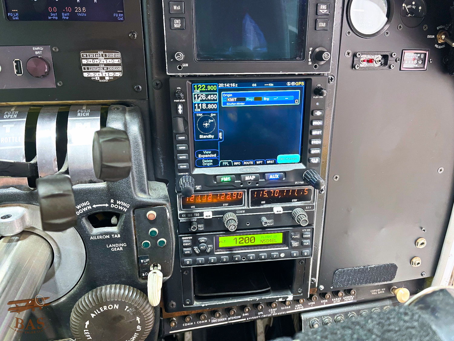 Cockpit instrument panel with various navigation and control displays.