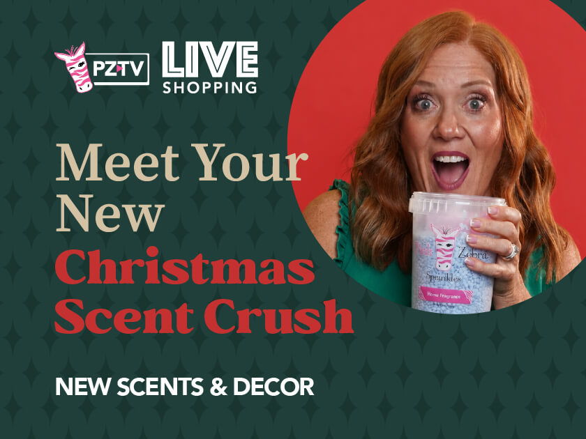 Woman smiling, holding a drink, promoting Christmas scents and decor.