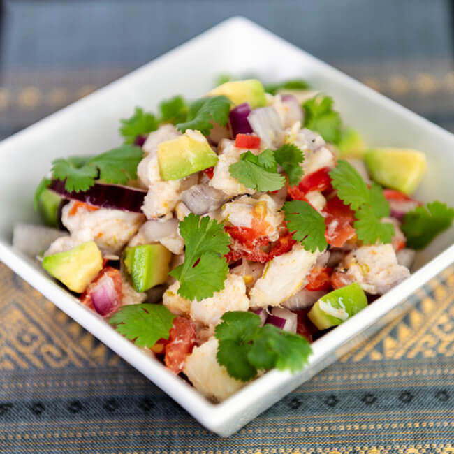 peruvian ceviche in bowl with avocado onion and jalapeno