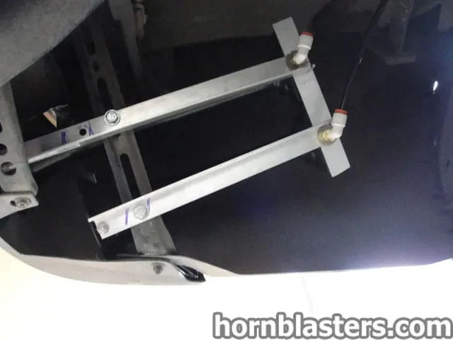 Custom aluminum angle bracket cross-brace push-to-connect air fittings bolted to slotted frame Cody's 2010 Tundra Shocker XL mounting hardware gallery photo 5