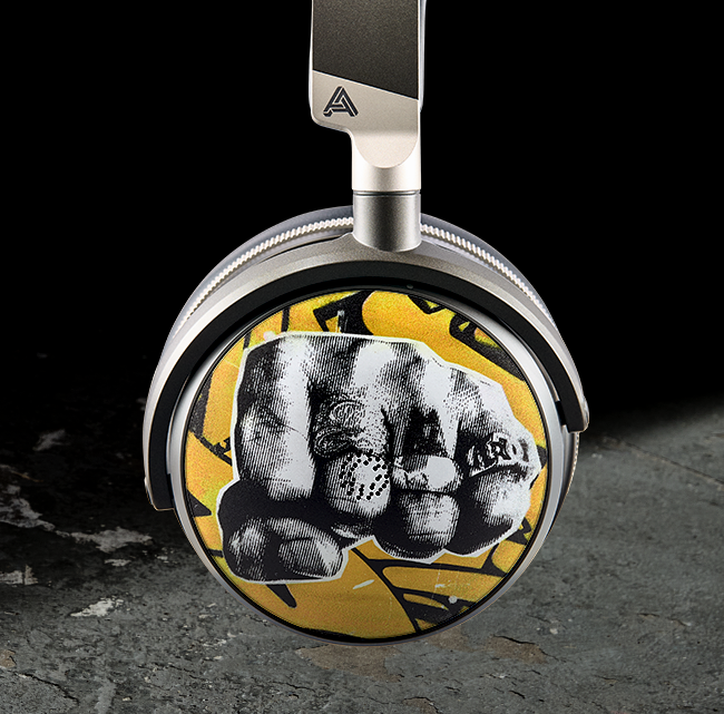 Headphones with a graphic of a fist and yellow background.