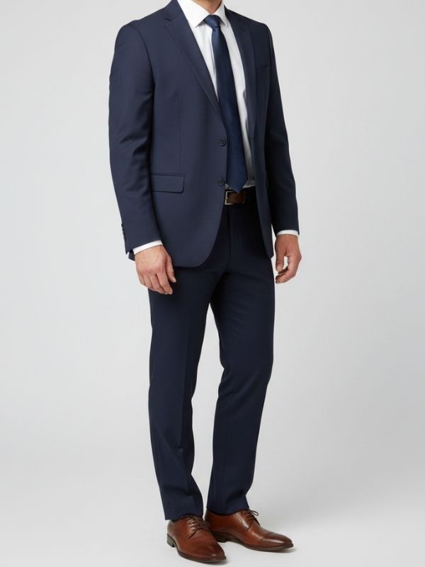 Man wearing a navy suit and navy tie