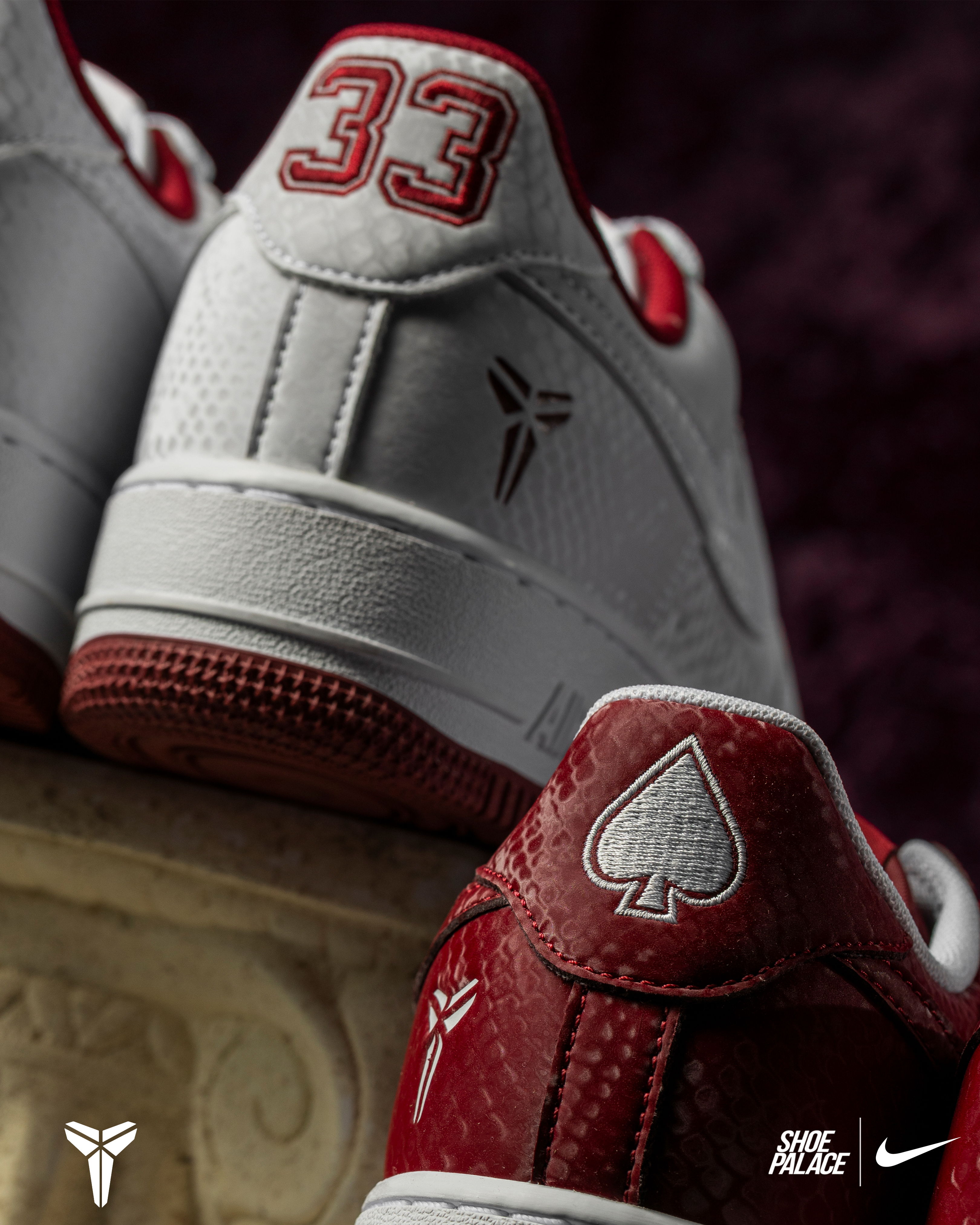 Red and white sneakers with logo and number 33 on the heel.