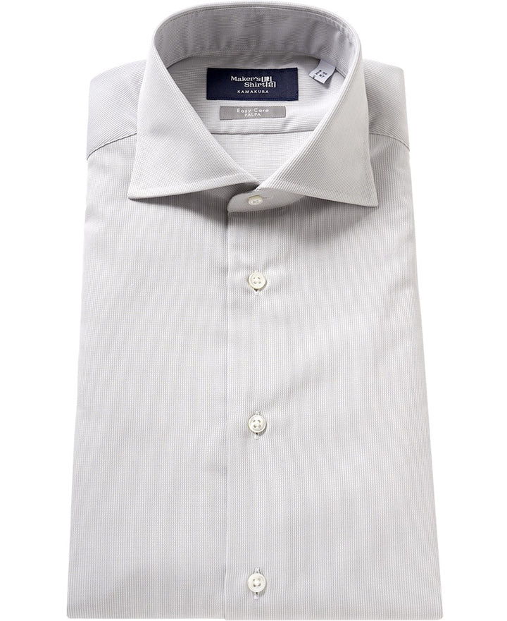 Folded light gray dress shirt with a button-up collar.