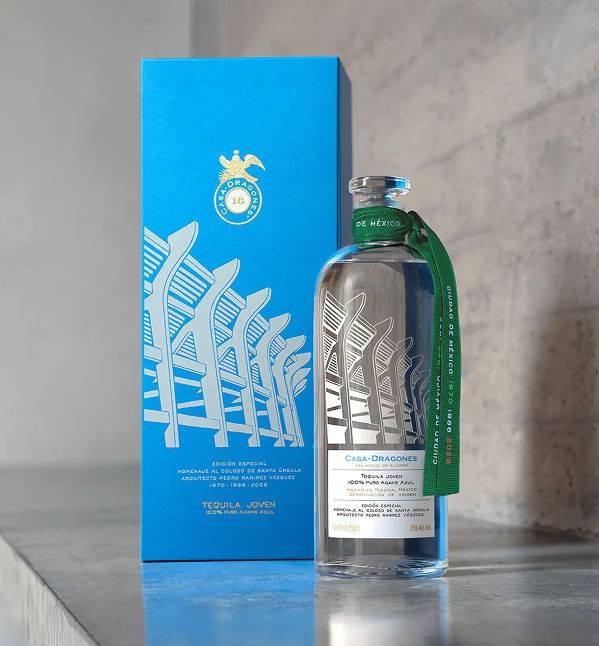 Bottle of tequila with a blue box and green ribbon.