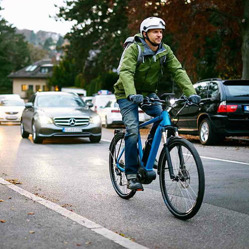 This commuter is rolling on an electric commuter bike along his commuter with fellow commuters.