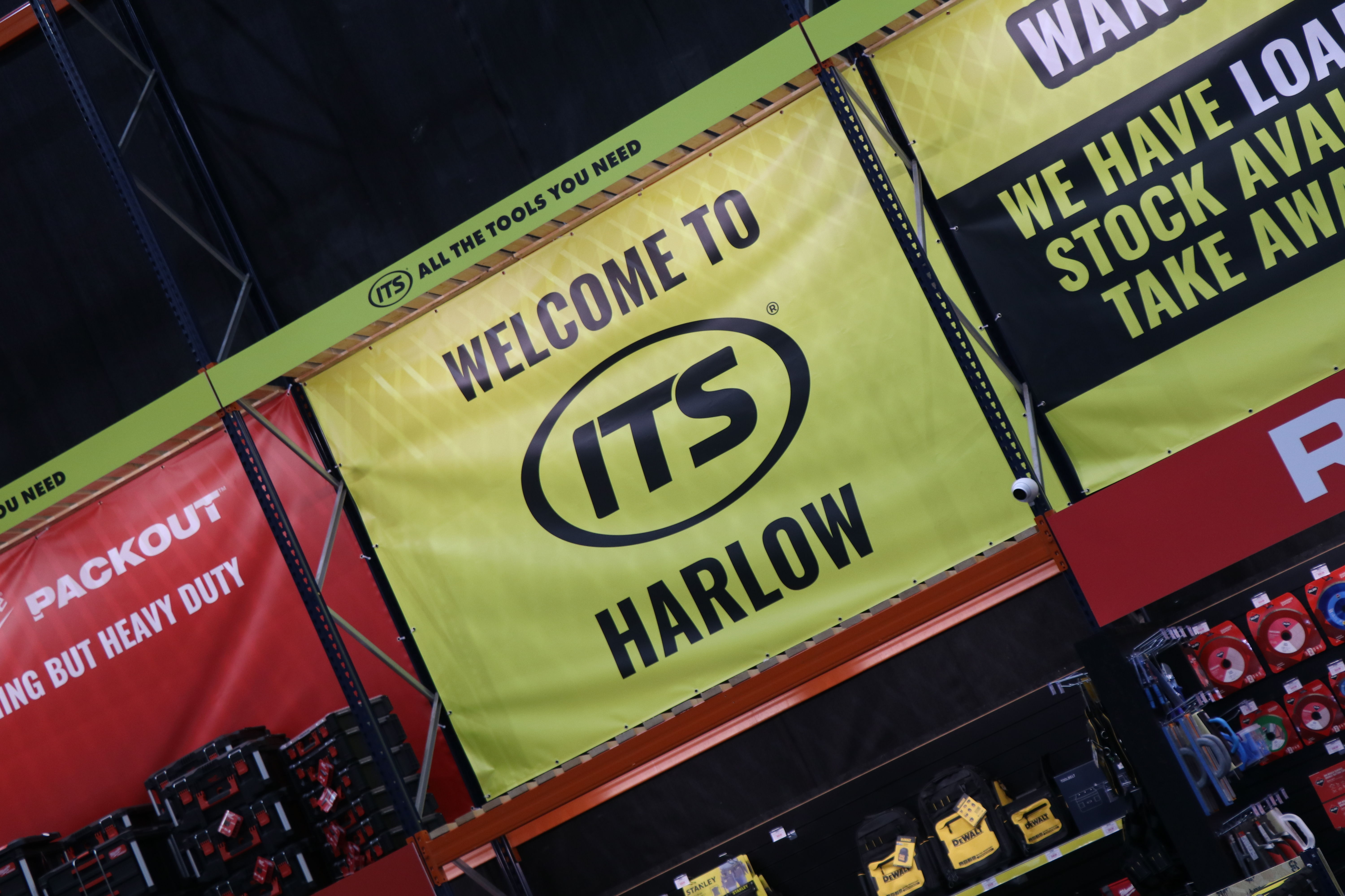 Welcome to ITS Harlow sign in a store.