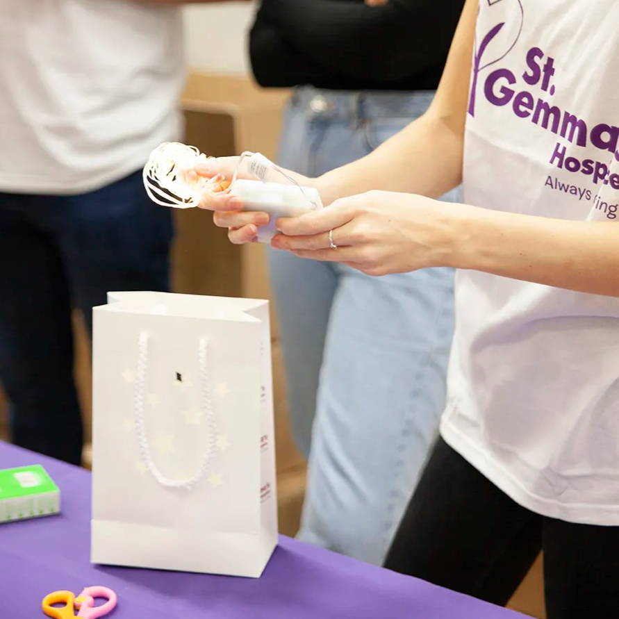 Members of Lights4fun placing micro lights inside the lanterns.