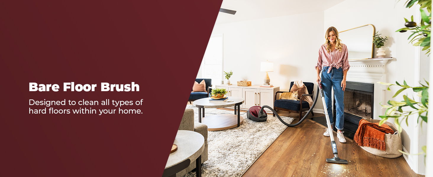 Woman using a bare floor brush in a stylish living room.