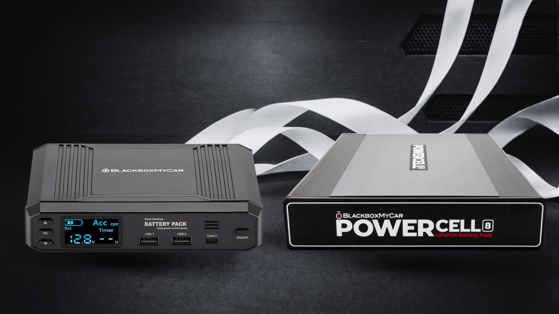 Two electronic devices on a dark background with decorative ribbons.