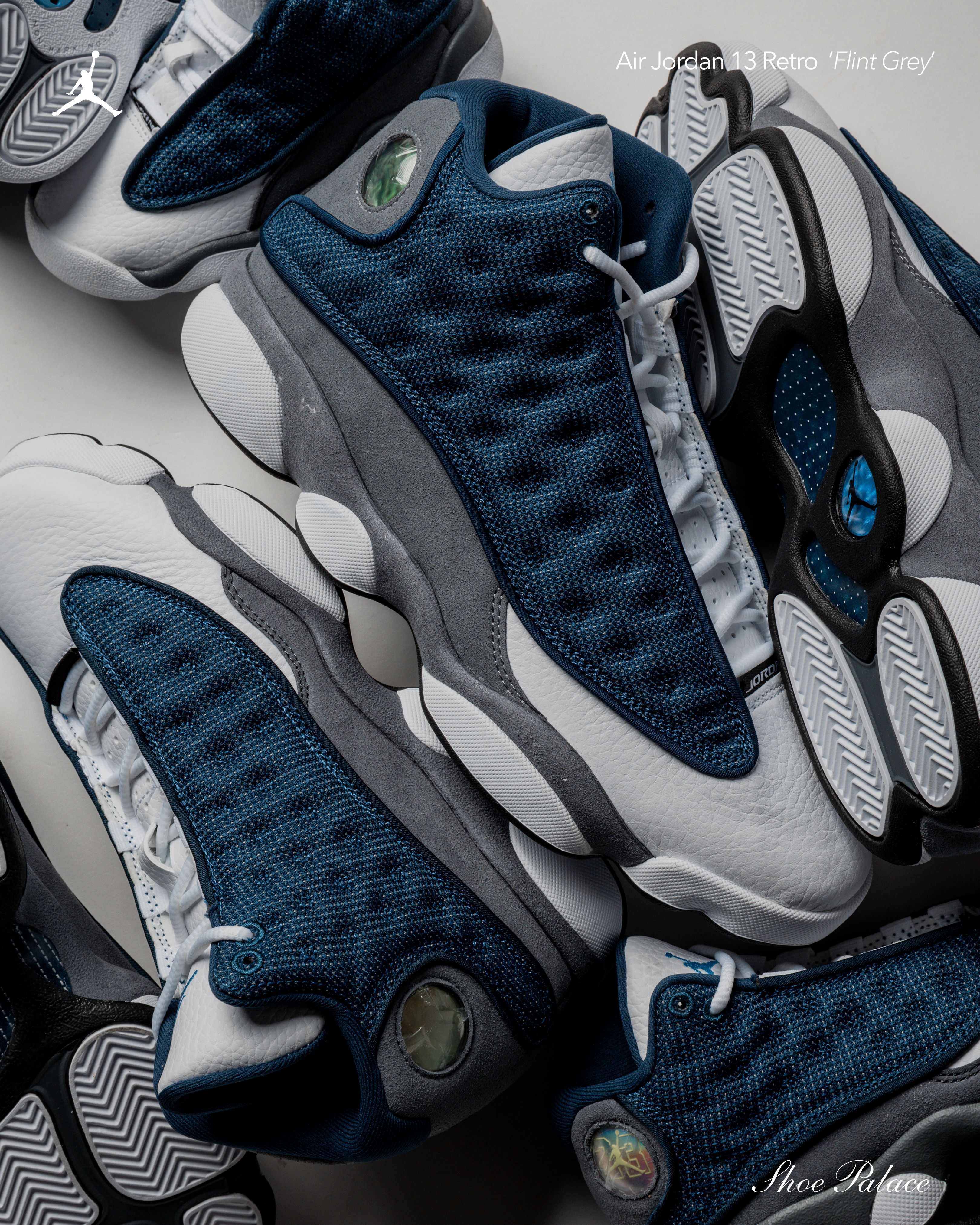 A collection of blue and gray sneakers stacked together.