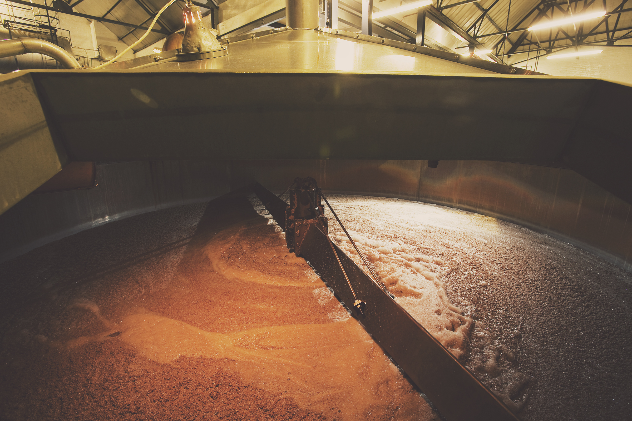 View of a large tank filled with reddish liquid.