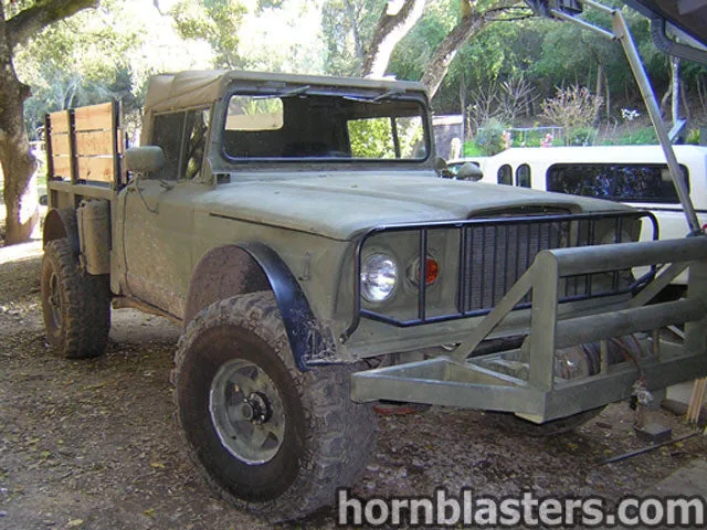 Front-three-quarter Scott's 1969 Jeep M715 military pickup truck exterior grille flat hood headlights bumper Shocker XL train horn featured customer install photo 1