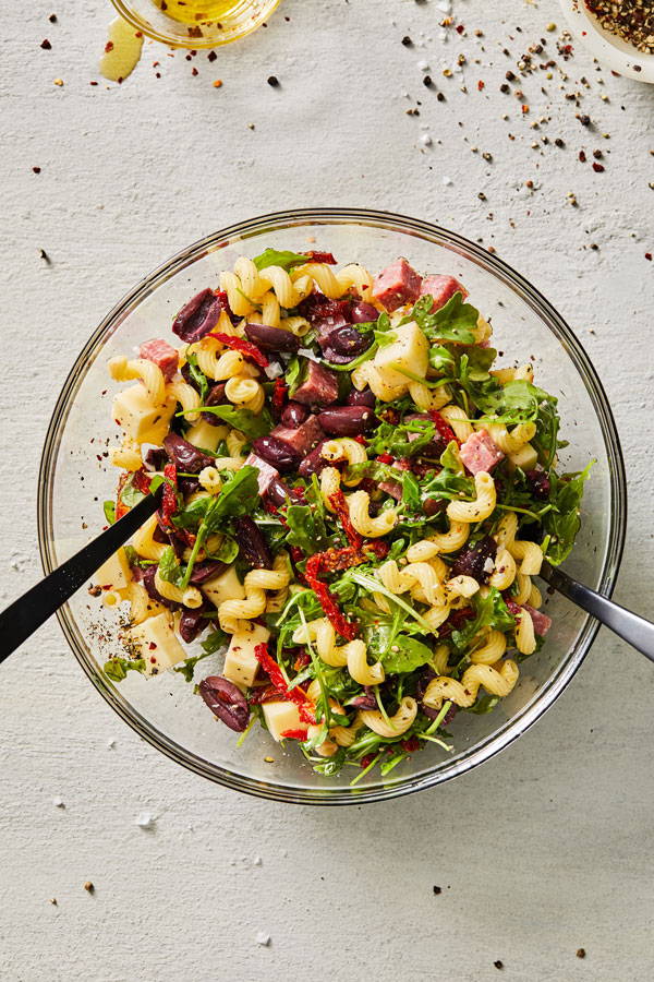 Cavatappi pasta salad with arugula, olives , sun-dried tomatoes and more