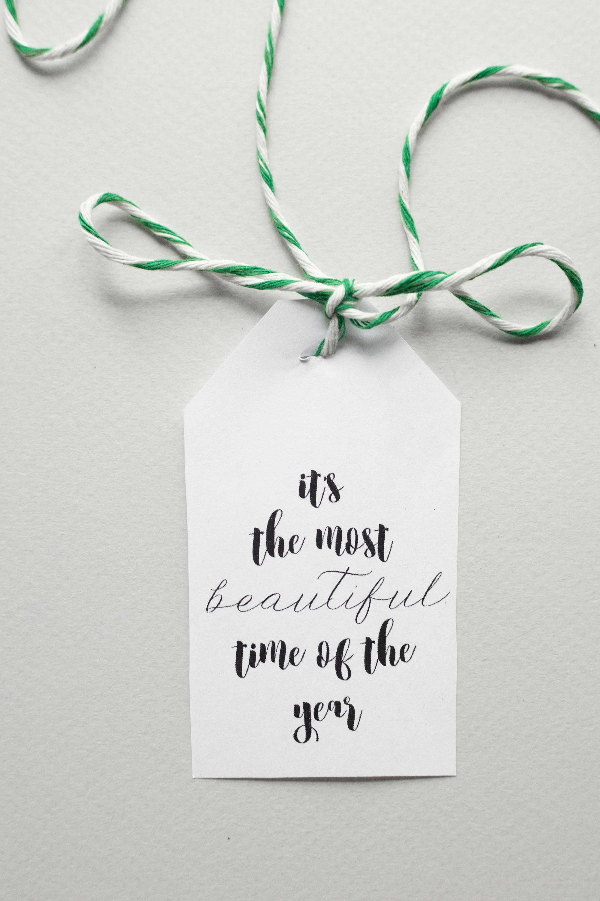 A gift tag that reads “It’s the most beautiful time of the year.”