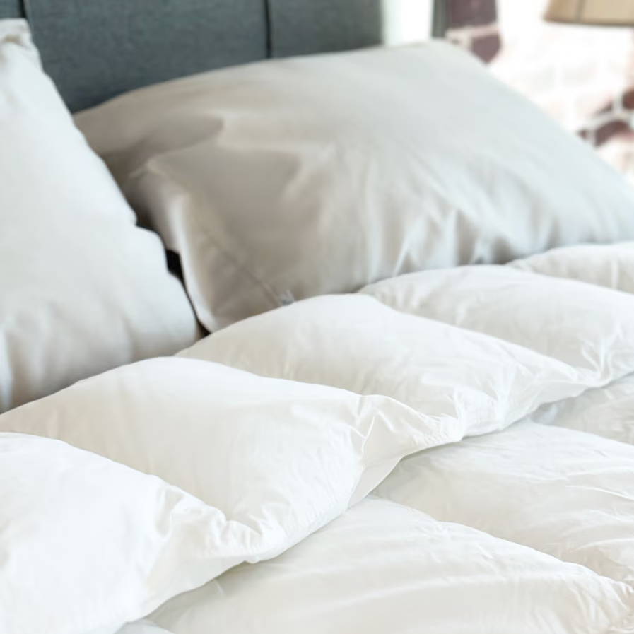 A plush white comforter on a bed