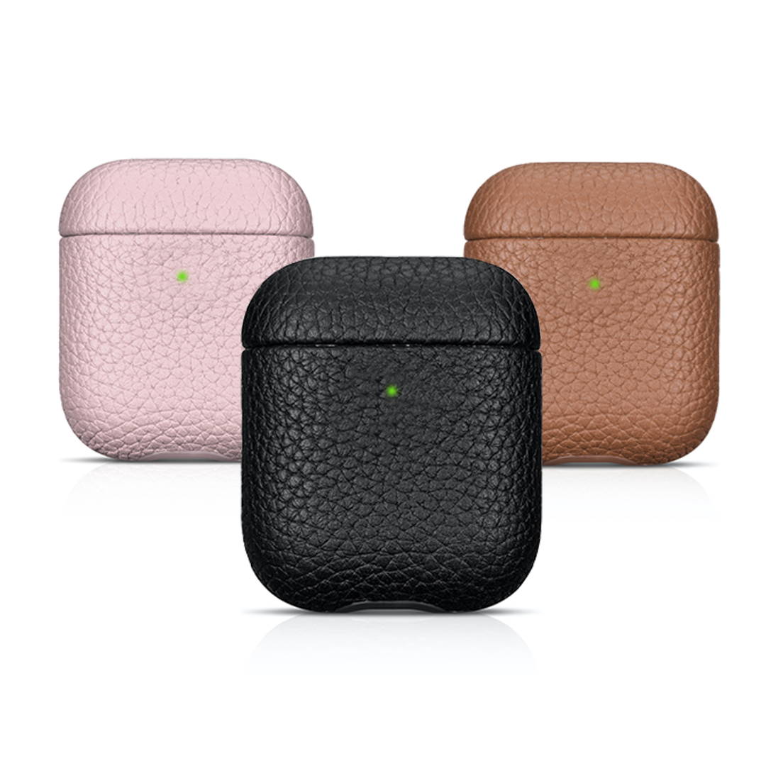 pink black and brown airpods leather case on a white reflective background