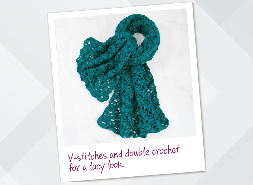 Teal crocheted scarf with V-stitches and double crochet for a lacy look.