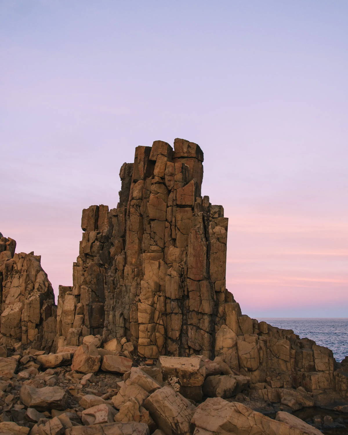 Rock formation set against a pink and purple sunset