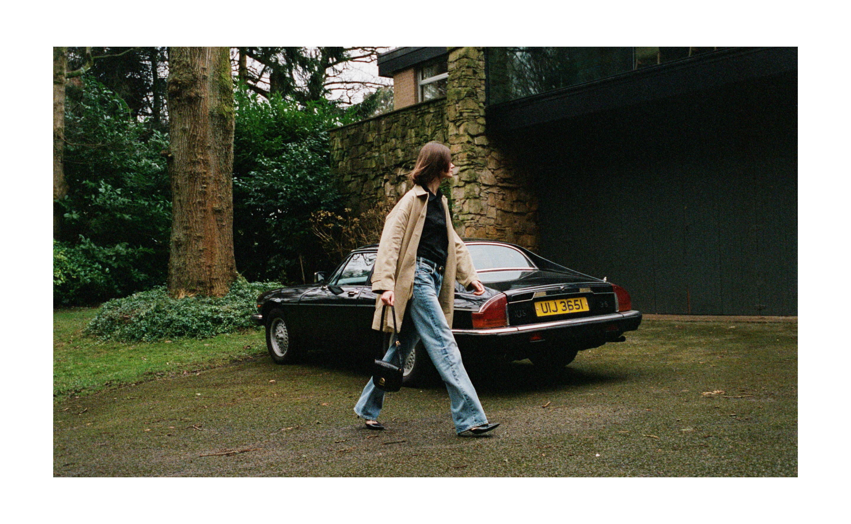 Image of model walking past car