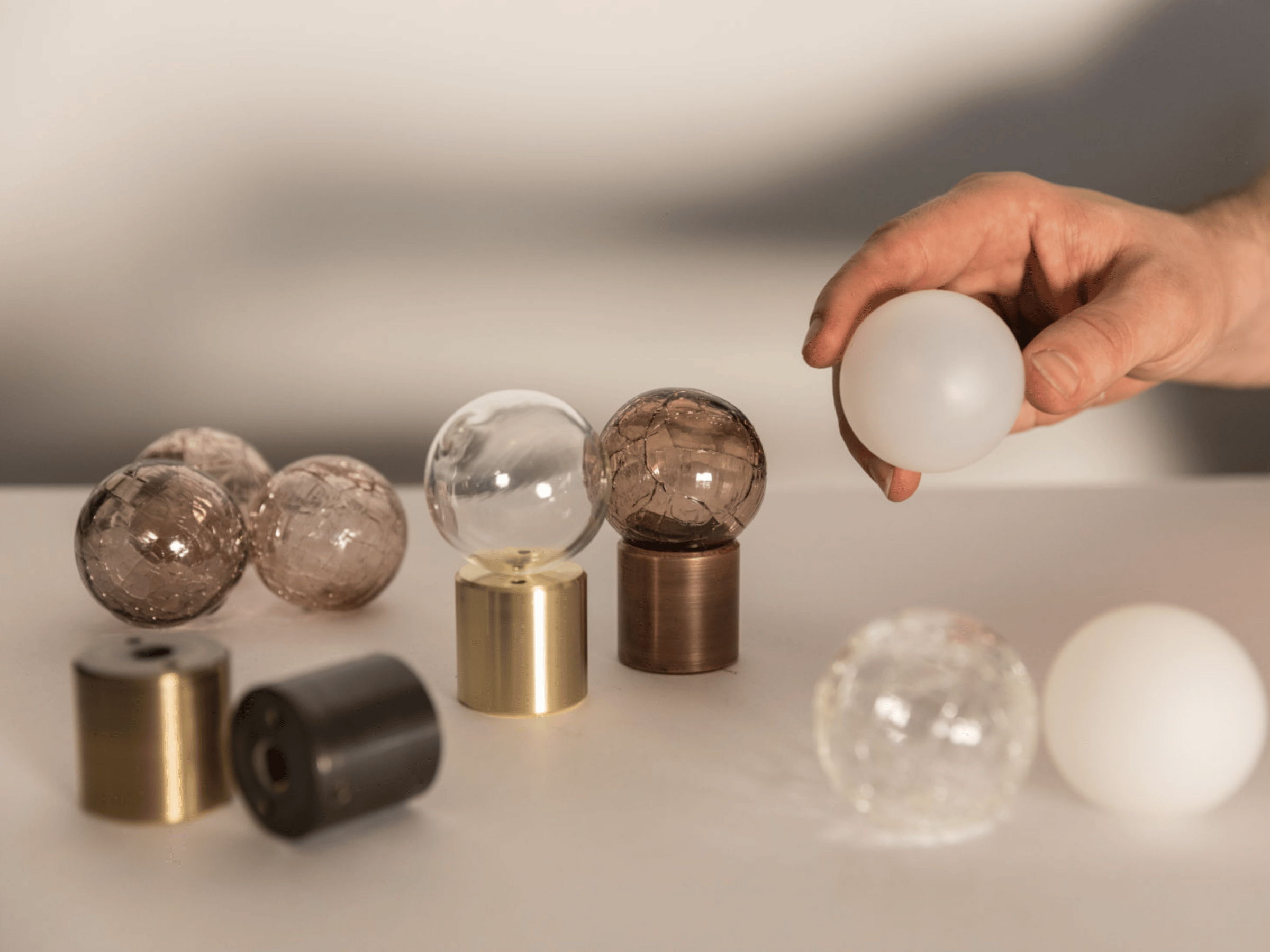 hand holding the glass spheres created by hand blown glass making