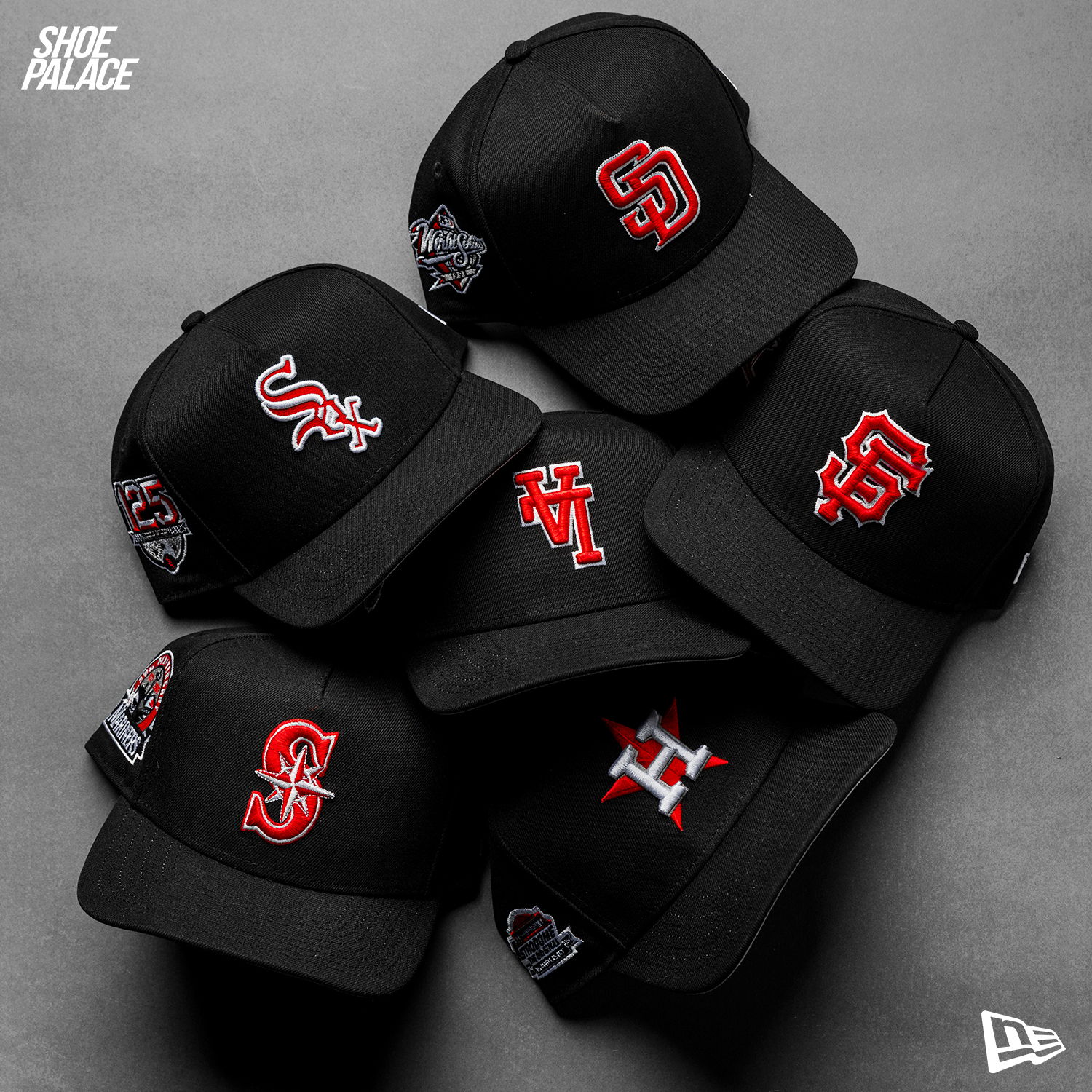 A collection of black caps with various logos and designs.